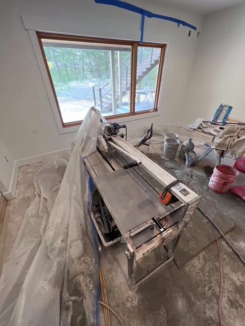 Kitchen remodel in progress with new custom window and construction equipment
