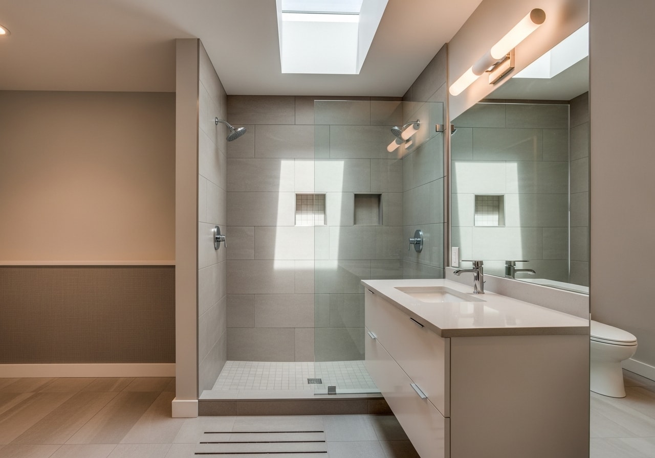 Spacious master bathroom with walk-in tile shower, heated floors, and floating vanity in Saint Paul